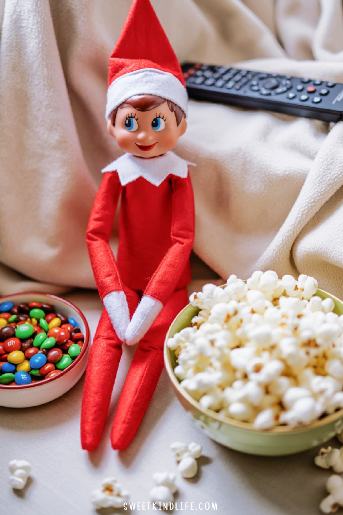 girl elf on a shelf for movie night with snacks