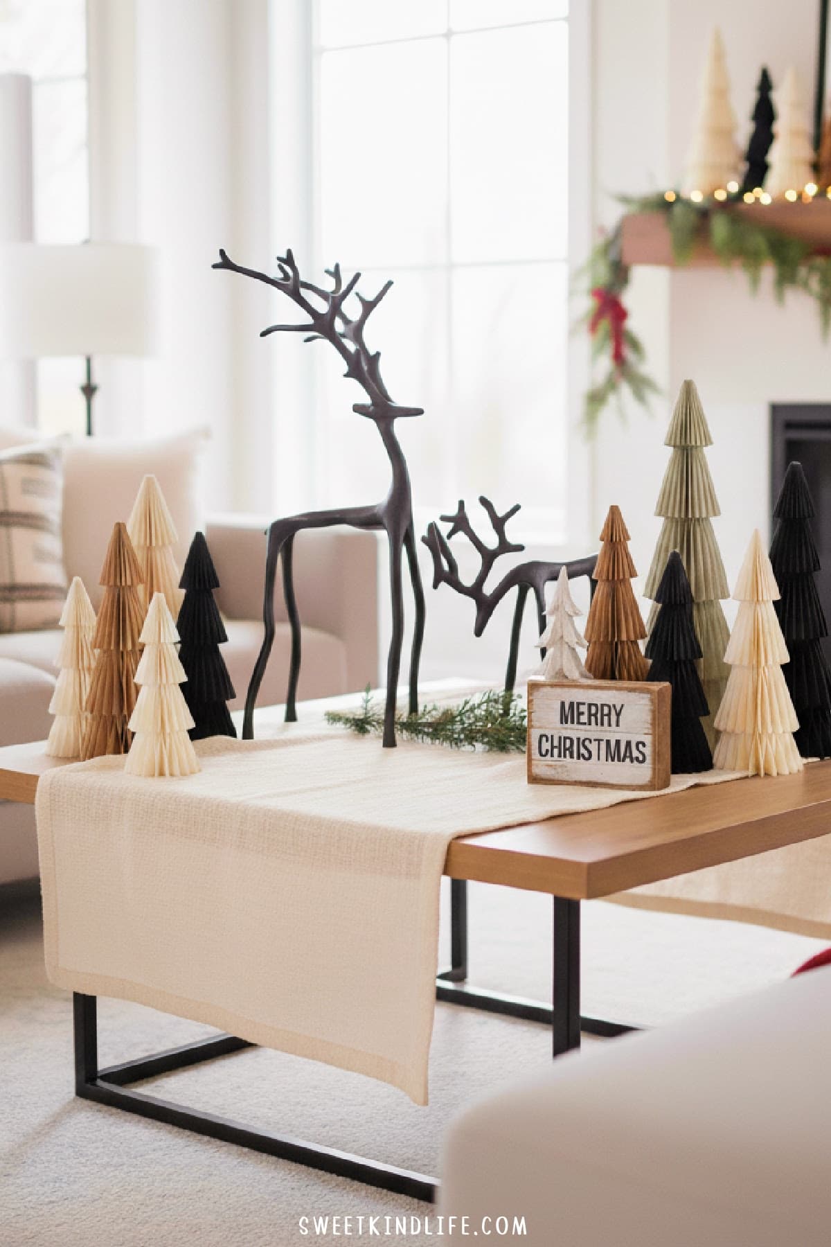 modern christmas coffee table decor with paper christmas trees and black metal reindeer